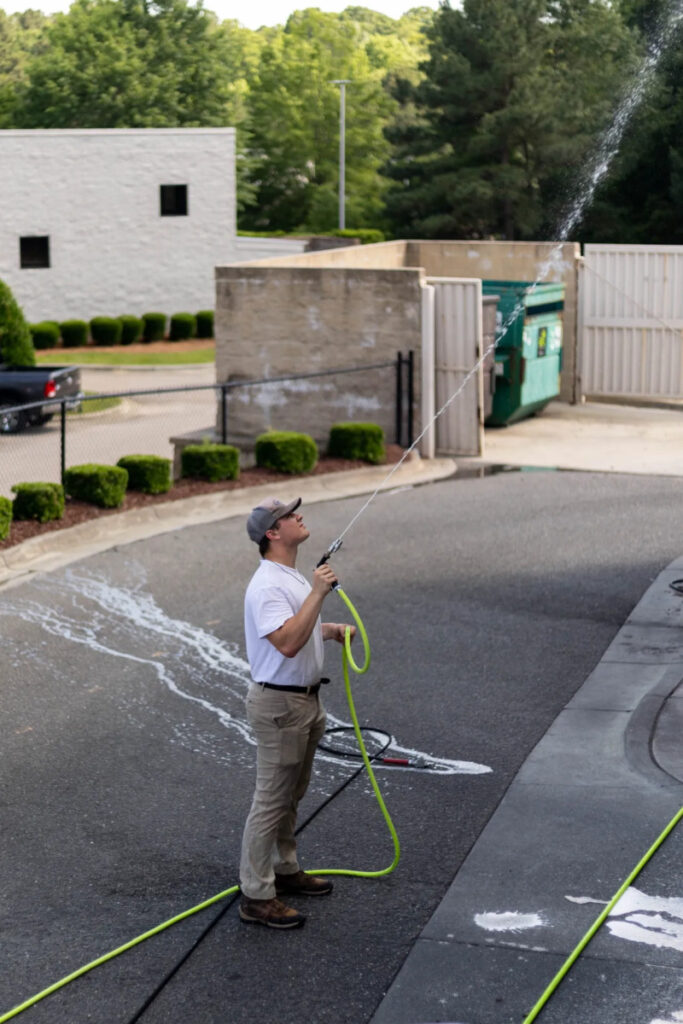worker power washing