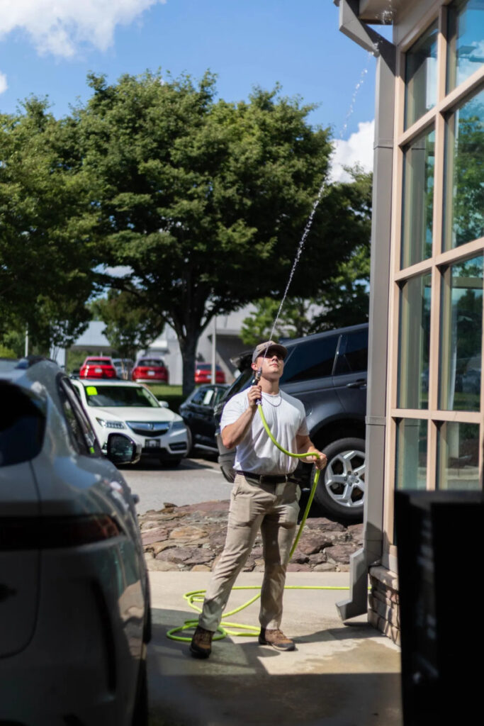 worker power washing